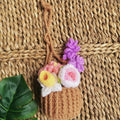Handmade crochet flowers in a basket, close view