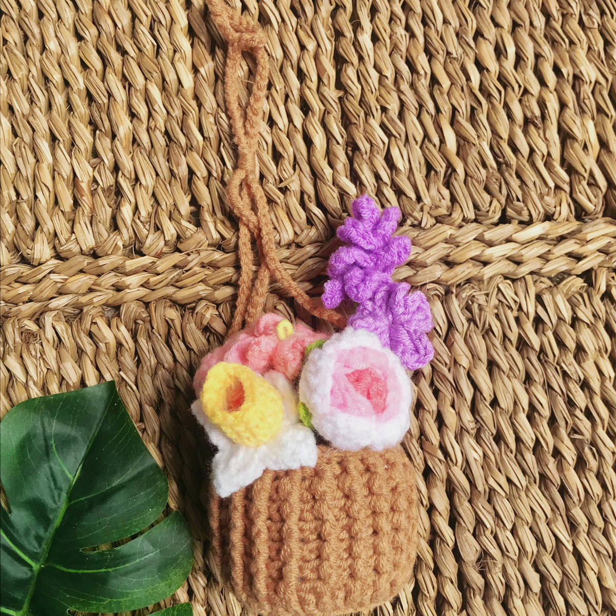 Handmade crochet flowers in a basket, close view