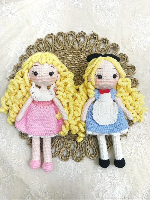 Handmade crochet girl doll in a blue and pink dress, soft plush toy