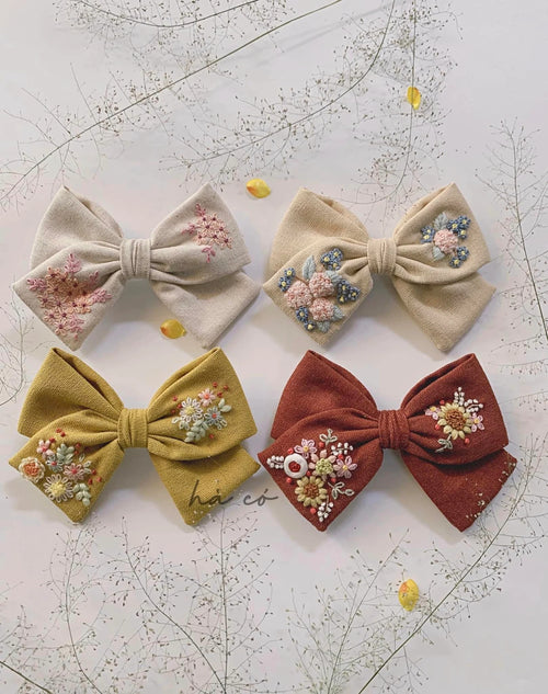 Hair bow hand-embroidered with wildflowers and roses on linen