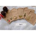 Set of five beige linen coasters with embroidered Christmas designs — hand-embroidered by The Thread Nest