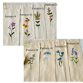 Ten different embroidery patterns shown on beige linen — hand-embroidered by The Thread Nest