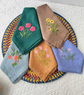 Set of six embroidered linen napkins with floral designs — hand-embroidered by The Thread Nest