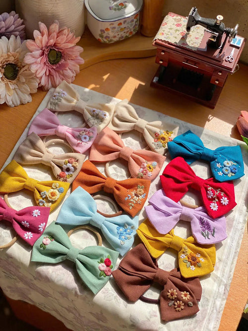 Hair bow hand-embroidered with wildflowers and daisies on linen