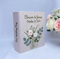 A light beige wedding photo album with embroidered floral details — hand-embroidered by The Thread Nest