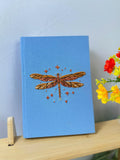 Dragonfly Embroidered Journal by The Thread Nest, pale blue linen cover with a hand-embroidered dragonfly, photo 3