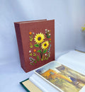 A hand-embroidered linen photo album by The Thread Nest
