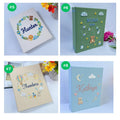 Four photo albums with an embroidered floral wreath, a teddy bear and clouds — hand-embroidered by The Thread Nest