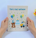 An embroidered canvas with a teddy bear, a birthday cake, balloons and a truck — hand-embroidered by The Thread Nest