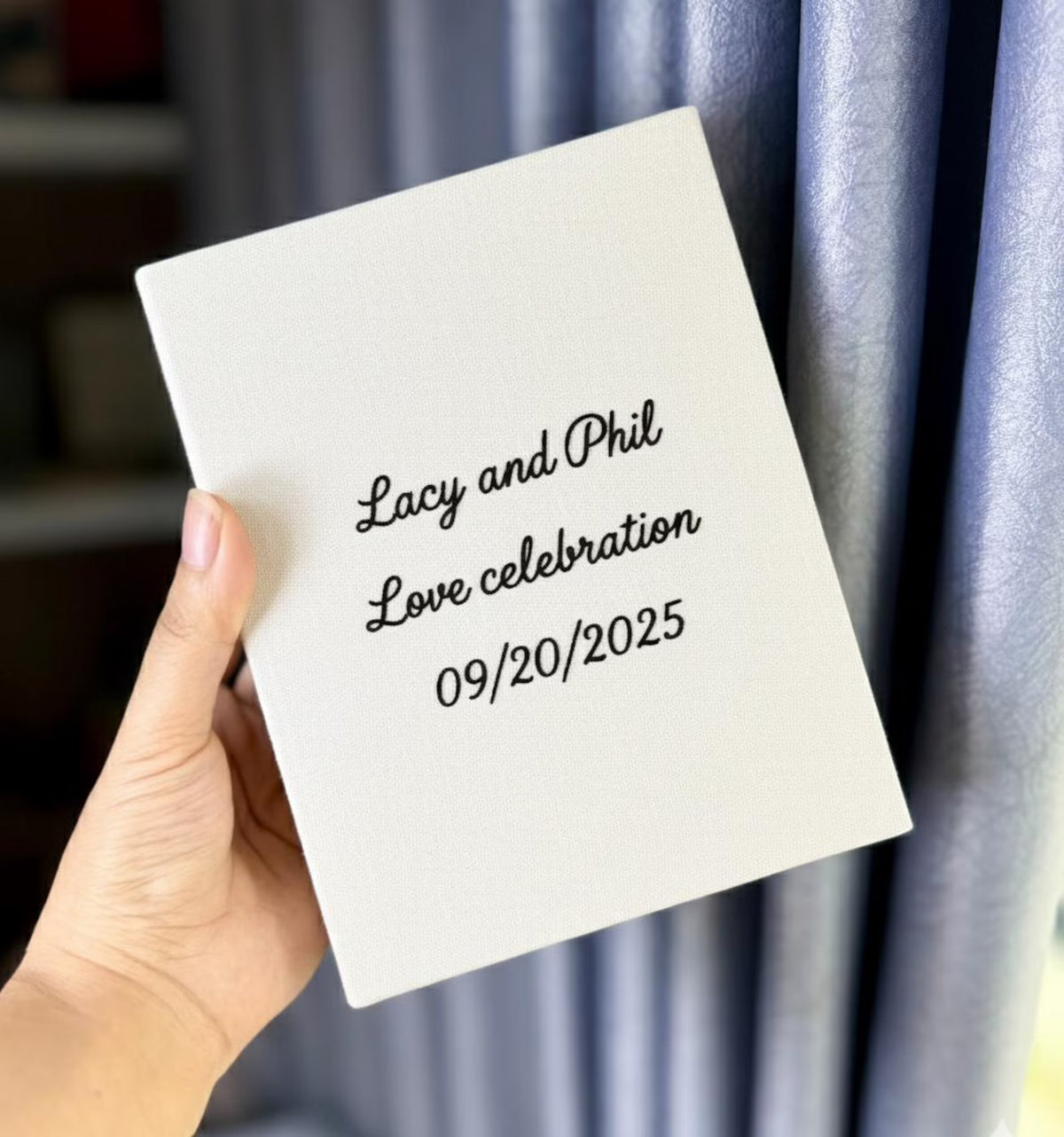 A white canvas board with printed names and a wedding date — hand-embroidered by The Thread Nest