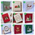 A collection of Christmas photo albums with different embroidered designs — hand-embroidered by The Thread Nest