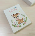 A light cover with a stitched name and a cartoon deer in a floral garland — hand-embroidered by The Thread Nest