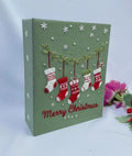 A green Christmas piece with embroidered snowflakes and hanging stockings — hand-embroidered by The Thread Nest