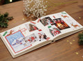 An open Christmas scrapbook with photographs, washi tape and stickers
