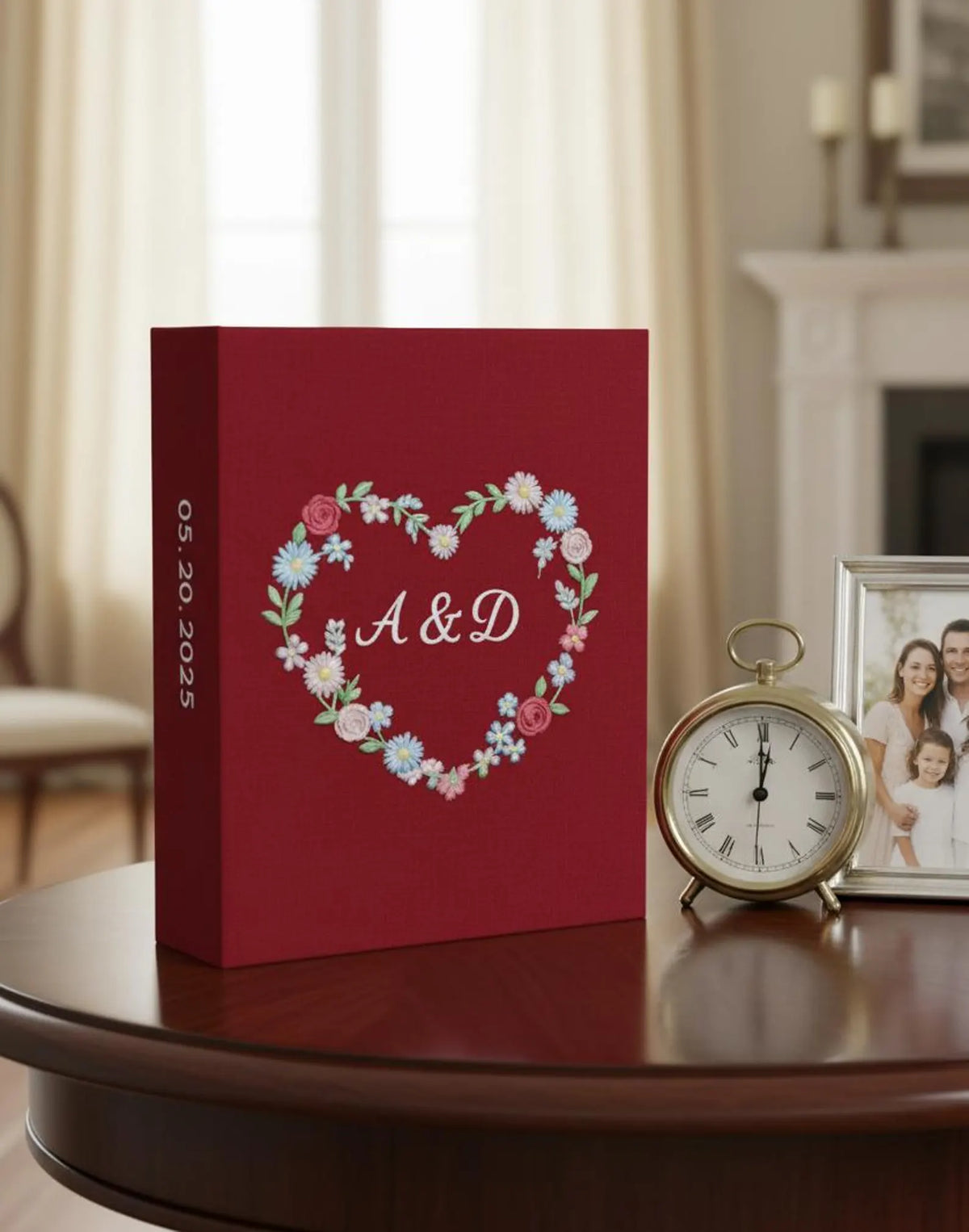 A burgundy keepsake box with a heart of embroidered flowers and two initials — hand-embroidered by The Thread Nest