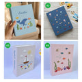 Four embroidered photo albums with ocean designs — hand-embroidered by The Thread Nest