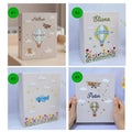 Four photo albums with embroidered hot air balloons, airplanes, clouds and stars — hand-embroidered by The Thread Nest