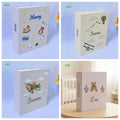 Four photo albums with embroidered names and toys — hand-embroidered by The Thread Nest
