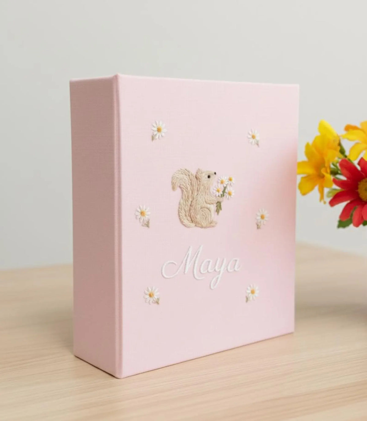 A light pink keepsake box with an embroidered squirrel holding flowers — hand-embroidered by The Thread Nest