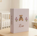 A light purple photo album with an embroidered brown teddy bear and the name Leo — hand-embroidered by The Thread Nest