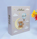 A light gray keepsake box with a teddy bear on a crescent moon and a hot air balloon — hand-embroidered by The Thread Nest