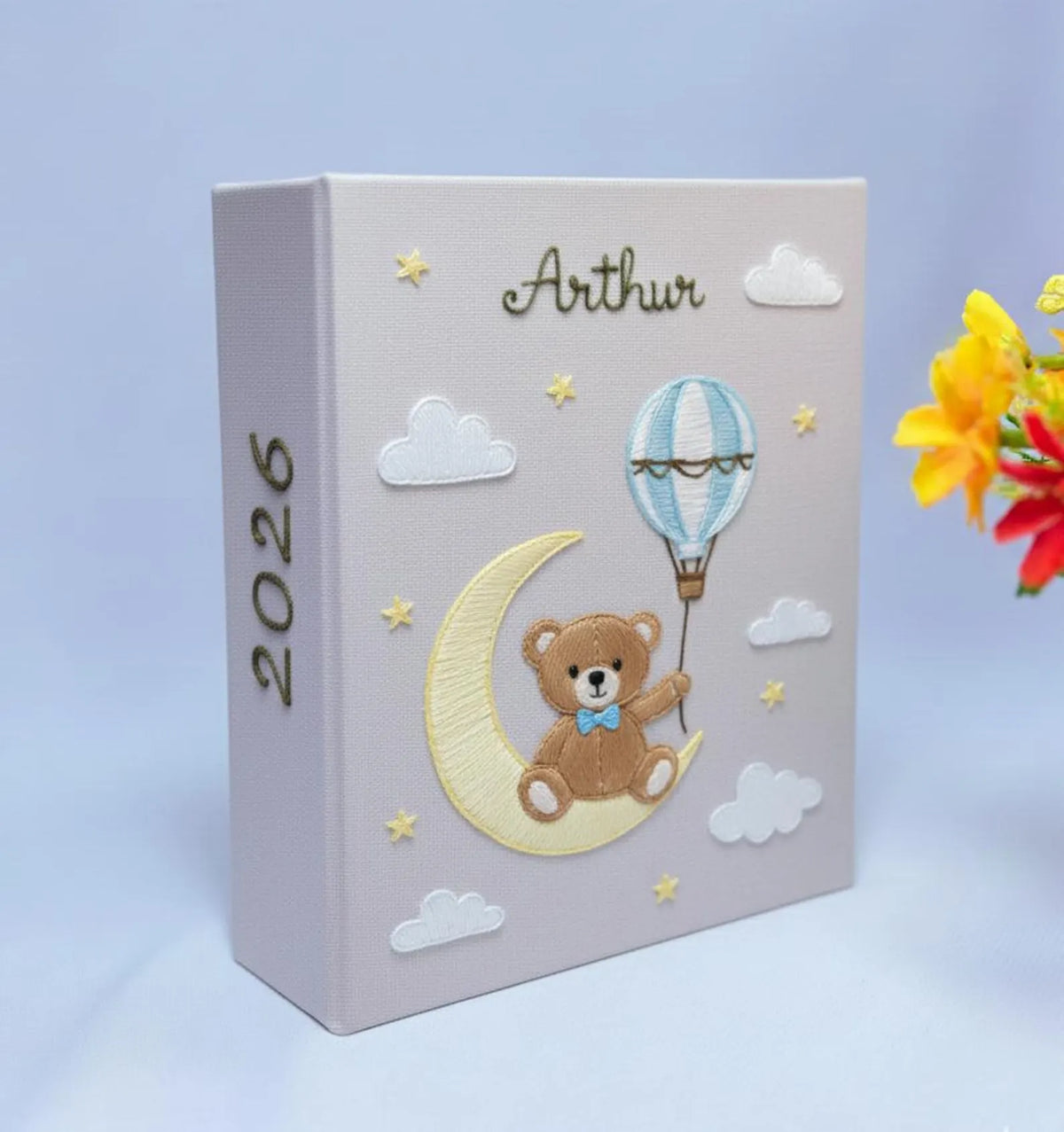 A light gray keepsake box with a teddy bear on a crescent moon and a hot air balloon — hand-embroidered by The Thread Nest