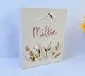 A beige keepsake box with embroidered daisies and a stitched name — hand-embroidered by The Thread Nest