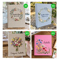 Four photo albums with embroidered floral designs, names and dates — hand-embroidered by The Thread Nest