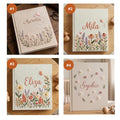 Four linen-covered journals with embroidered floral and butterfly designs — hand-embroidered by The Thread Nest