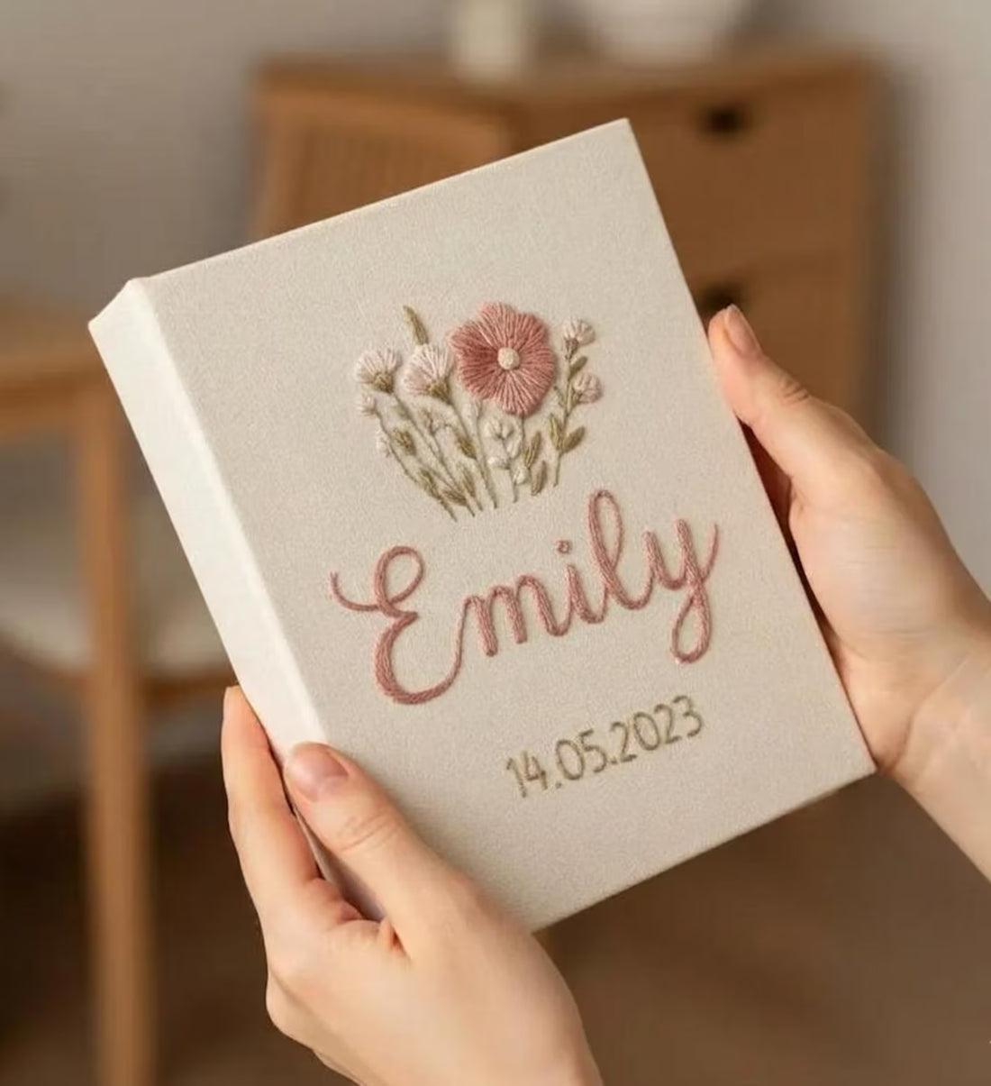 A cream-colored fabric cover with an embroidered floral bouquet in shades of pink and green — hand-embroidered by The Thread Nest