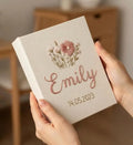 A cream-colored fabric cover with an embroidered floral bouquet in shades of pink and green — hand-embroidered by The Thread Nest